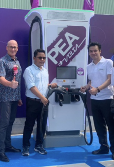 Alpha EV team standing beside a PEA Volta EV charging unit